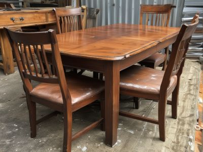Wooden dining table and chairs showing various types of wear and damage requiring professional restoration